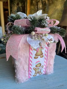 a pink gift box decorated with christmas decorations