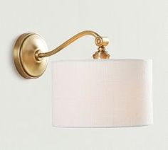 a wall light with a white shade on it