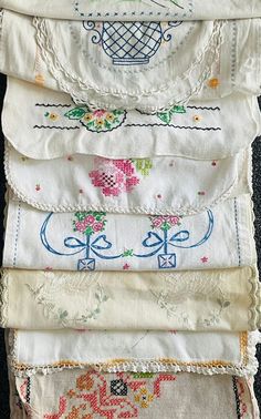 several pieces of embroidered fabric stacked on top of each other