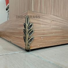 a close up of a wooden surface with a metal object on it's side