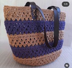 a crocheted tote bag with leather handles