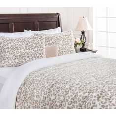 a leopard print comforter set on a bed