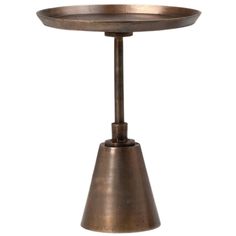 an antique brass table with a metal cone on the top and a round base in the middle