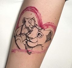 the lion king and cub tattoo on the left arm is shown in black ink with pink watercolors