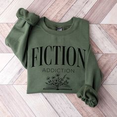 🎅Last day for Christmas orders Dec 8th🎄 Welcome to our cozy corner of bookish bliss! Introducing our "Fiction Addiction" sweatshirt, the ultimate wardrobe staple for bibliophiles everywhere. Crafted with comfort in mind, this soft and stylish sweatshirt is perfect for curling up with your favorite novel or exploring new literary realms.  ♡ PRODUCT: We use the finest premium Gildan 18000 crewneck sweatshirts, they are feather soft and very breathable with a good stretch. These garments are made Cricut Fashion, Book Sweatshirts, Bookish Sweatshirts, Bookworm Sweatshirt, Reading Retreat, Book Items, Stamp Jewelry, Funny T Shirt Sayings, Librarian Shirt