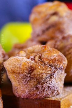 some sugary muffins are sitting on a cutting board