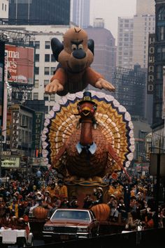 a large float in the shape of a turkey with an animal on it's head