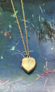 Vintage rolled gold HEART shaped locket with foliate etched design and additional 14ct gold filled chain ( optional ) in varies lengths ( see options at check out ). This striking locket has a mid century classic foliate etched design on the front and a plain base which is stamped 'rolled gold' . The clasp opens and shuts perfectly. The pendant comes in a decorative pouch with matching ribbon bow. Description - Lenght locket - 1.5 cm  Width locket - 1.2 cm  Weight ( locket only ) - 2 grams  Box not included in purchase just for presentation purposes.  All items are packed safely packed in bubble wrap, brown craft paper and packed in boxes with extra protection compostable packing pellets.. all items are sent by registered tracked delivery. Thanks for looking Valentine's Day Gold Necklace With Intricate Design, Ornate Gold Locket Necklace Gift, Gold Etched Locket Necklace For Wedding, Engraved Antique Gold Heart Pendant Jewelry, Gold Filigree Locket Necklace Gift, Gold Etched Pendant Locket Necklace, Etched Gold Pendant Locket Necklace, Gold Etched Heart Jewelry, Gold Heart-shaped Etched Jewelry