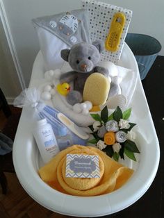 a baby shower gift basket with teddy bear, diaper and other personal care items