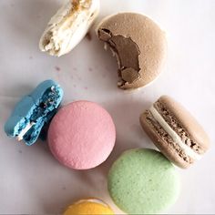 several different types of macaroons on a white surface