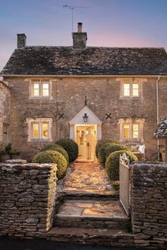 an old brick house with stone steps leading up to the front door and entry way