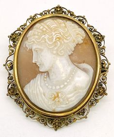 "Lady's vintage, Victorian design, cameo brooch. Beautifully carved shell cameo is set in a filigree and flower frame. This piece weighs approximately 9.2 grams and is stamped \"10K\". It is in excellent condition and would make a beautiful addition to your vintage jewelry collection." Antique Carved Brooches For Weddings, Heirloom Cameo Brooch For Wedding, Heirloom Cameo Brooches For Weddings, Heirloom Cameo Wedding Brooch, Victorian Style Cameo Brooch For Weddings, Victorian Cameo Brooch For Wedding, Antique Cameo Brooches For Wedding, Classic Cameo Brooches For Wedding, Antique Cameo Medallion Brooch