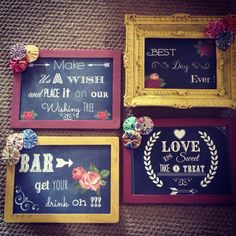 three framed chalkboards with different sayings and flowers on them, sitting on a carpeted floor