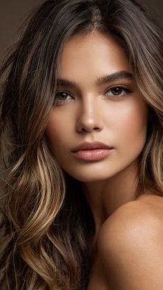 a beautiful woman with long hair posing for the camera