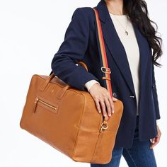 Bring new level of refinement to your travel repertoire with this beautiful weekender bag. Mindfully made from high quality leather produced without the use of any toxic chemicals, resulting in a natural material that is so clean it could be used in organic compost after its useful life has ended. The sleek silhouette has just enough room for a weekend getaway or your carry-on essentials and a detachable crossbody strap that you can mix and match with our colorful bag straps for a custom look. A Everyday Rectangular Duffle Bag With Leather Handles, Rectangular Duffle Bag With Leather Handles, Modern Travel Bag For Weekend Trips With Leather Lining, Rectangular Weekender Bag With Leather Handles For Weekend Trips, Everyday Weekender Bag With Luggage Sleeve, Modern Brown Weekender Bag With Leather Handles, Modern Brown Rectangular Weekender Bag, Modern Rectangular Weekender Bag With Leather Handles, Rectangular Weekender Bag With Leather Lining For Trips