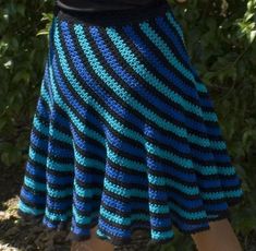 a woman wearing a blue and black striped skirt