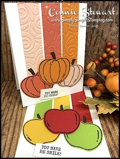 three cards with pumpkins and apples on them