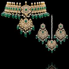 Indulge in the allure of this exquisite jewelry set and let contemporary grace redefine your fashion narrative! Radiate elegance and dangle in delight with our enchanting Esha Set – a mesmerizing blend of elegance and vibrancy meticulously crafted with sparkling zircons, complemented by the refreshing allure of emerald green stones, and embellished with delicately dangling green beads to elevate your style with the perfect harmony of sophistication and playfulness. The set includes a necklace, a maang teekah and a pair of trendy earrings. Approximate earrings length is 3.25". Gold-plated on high-quality brass as base metal. Made by order. Kindly allow 4-6 weeks for the delivery of this item. For custom or urgent requests, please contact support@alacouture.com. *Please Note: We use faux sto Elegant Kundan Hand Set, Bollywood Style Festive Cubic Zirconia Jewelry, Hand Set Jewelry Sets For Reception, Festive Cubic Zirconia Jewelry Sets With Elegant Design, Dazzling Jewelry Sets For Reception, Elegant Festive Sets With American Diamond, Dazzling Kundan Jewelry With Elegant Design, Dazzling Elegant Kundan Jewelry, Dazzling Jewelry With Intricate Design For Festive Season