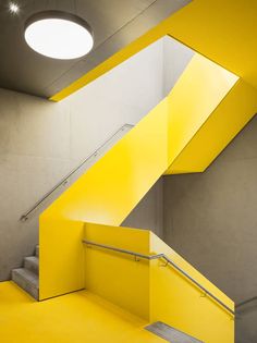 the stairs are painted bright yellow and there is also a light fixture on the ceiling