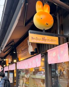 a store front with an inflatable bunny head hanging from it's side