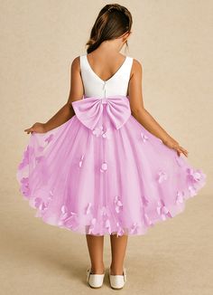 Sprout combines an enchanting A-line shape with a blend of tulle and matte satin. Its sweet scoop neckline and elegant V-back are complemented by a charming zipper closure and adorable bows, creating a delightful look for any little girl on a special occasion. This dress is not only perfect for a flower girl at a wedding but also versatile enough for other special occasions. Pink Floral Applique Bridesmaid Dress, Spring Prom Tutu Dress, Pink Princess Dress For Confirmation, Pink Fitted Dress For Confirmation, Pink Bridesmaid Dress With Floral Applique, Spring Confirmation Princess Dress With Tulle Skirt, Spring Princess Tutu Dress For Confirmation, Fitted Pink Princess Dress For Confirmation, Pink Fitted Princess Dress For Confirmation