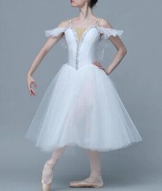 a young ballerina in a white tulle dress