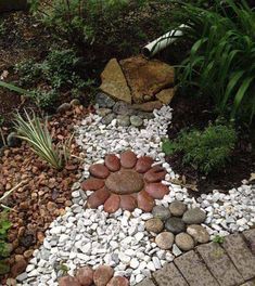 a garden with rocks and gravel in the shape of a cross on it's side