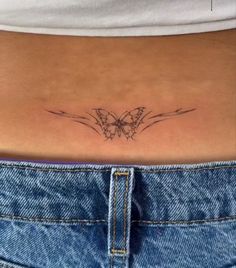 a woman's stomach with a butterfly tattoo on her lower back side ribcage