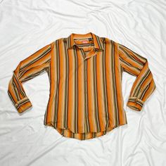 2000s long sleeve button up top. Stripe pattern. In good condition. Note: I try to match colors as much as possible to pictures but there is a possibility it won't be an exact match. Unless the color is completely incorrect I am unable to offer refunds for this reason. Size: XXL Brand is Enyce Clothing Company Measurements (taken on garment laid flat): Armpit to armpit: 25" Waist: 45" Shoulder to shoulder: 22" Armpit to hem: 17" Length (top of neck to bottom hem): 34.5" Fabric: 100% cotton Orange Long Sleeve Shirt For Fall, 90s Long Sleeve Tops For Fall, Striped Long Sleeve Shirt For Fall, Y2k Long Sleeve Shirt For Spring, 90s Style Long Sleeve Summer Shirt, Y2k Long Sleeve Summer Shirt, Y2k Style Long Sleeve Summer Shirt, Retro Long Sleeve Shirt For Fall, Retro Long Sleeve Shirt With Buttons