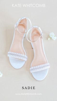 the bride's shoes are all white and have crystal embellishments