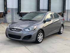 a gray car parked in front of a building