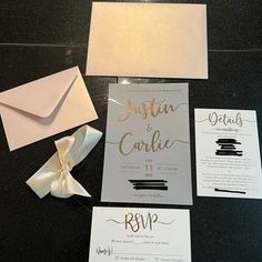 the wedding stationery is laid out on the table