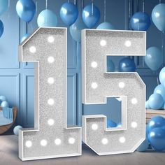 the number fifteen is surrounded by balloons and streamers in this blue room for a birthday party