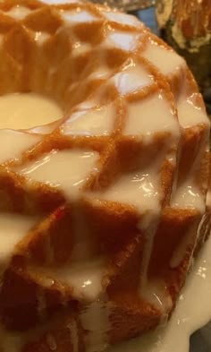 a bundt cake covered in icing and sitting on top of a white plate