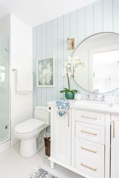 a white bathroom with blue and white decor