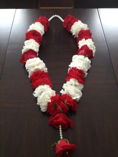 a red and white flower lei on a table