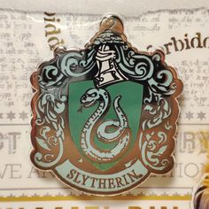 there is a slytherin badge on the back of a bag that says harry potter