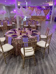 a banquet room set up with purple and gold decorations