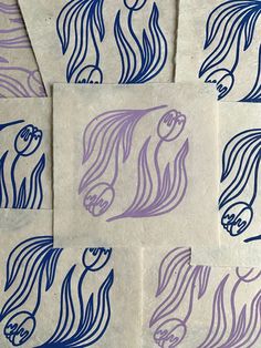 four pieces of paper with blue and purple designs on them