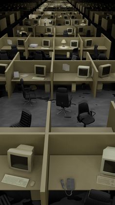 two rows of cubicles with computers and chairs in each room, all facing different directions