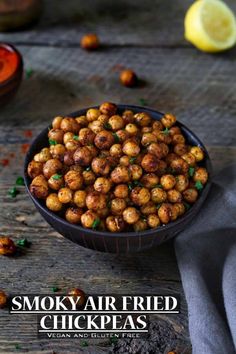 a bowl full of roasted chickpeas with parsley on the side next to it