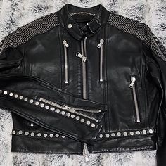 In Excellent Condition 100% Lambskin Leather Diesel Black Gold Cropped Jacket With Various Metal Studs Through Out. Double Zip Main Zipper. Zippers At Ends Of Sleeves, Metal Studs On Top Of Shoulders, Along The Top Of The Sleeves And Around The Hem. This Jacket Is Not Lined On The Inside. Hardware Is In Tact, Nothing Is Missing, Silver Toned. Eu 38 In Size Equivalent To An Xs/S, True To Size. Slight Wear On Outer Stitching Of Right Under Arm On Sleeve, Refer To Photos. Luxury Fitted Silver Outerwear, Silver Leather Jacket With Long Sleeves For Winter, Punk Leather Jacket, Diesel Black Gold, Lambskin Leather Jacket, Chic Leather, Cropped Jacket, Black Metallic, Crop Jacket