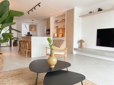 a living room filled with furniture and a flat screen tv