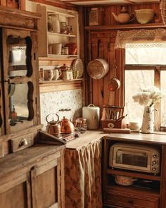 an old fashioned kitchen with pots and pans