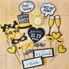 wedding photo booth props on wooden floor with happy couple's names and date signs