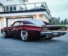 a classic car parked in front of a house