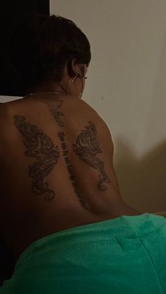 a woman with a tattoo on her back