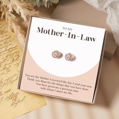 mother - in - law earrings are displayed on a card next to a note and flowers