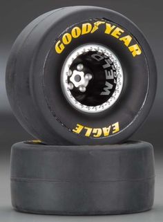 a black and yellow skateboard tire with the words good year on it's side