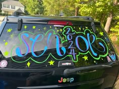 the back of a car that has been decorated with stars and writing on it,